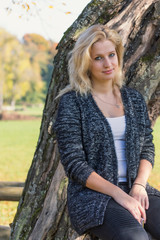 Portrait of young blond woman with arms in her lap