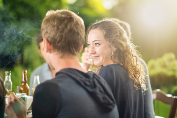 Group of young people having fun outside, focus on a young woman