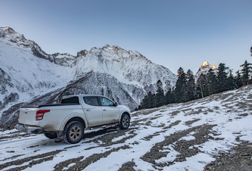 pickup truck is staying over the hill under the dawn light, Elbrus, Russia