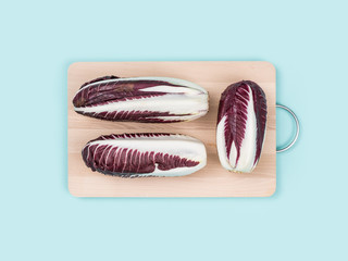 Red chicory on a chopping board