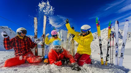 Photo sur Aluminium Sports dhiver Happy family enjoying winter vacations in mountains. Playing with snow, Sun in high mountains. Winter holidays.
