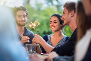a group of students having fun while lighting sparkling sticks