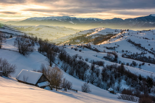 village in mountains on winter sunrise. beautiful landscape in Carpathians
