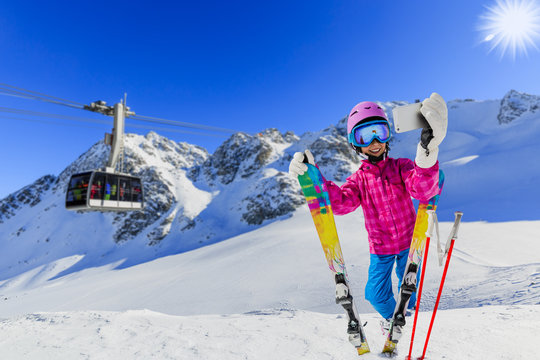 Teenager taking a selfie, girl taking a self portrait with mobile phone, sport skiing having fun on winter vacation.