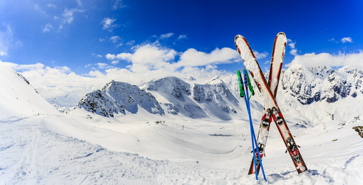 Ski in winter season, mountains and ski touring backcountry equipments on the top of snowy mountains in sunny day. South Tirol, Solda in Italy.