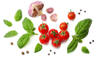 mix of slice of tomato, basil leaf, garlic and spices isolated on white background. top view