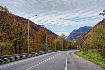Highway in the highlands among the autumn trees, Sochi region, Russia