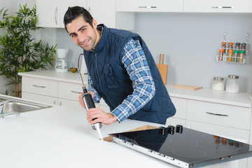 Man using sillicone in kitchen