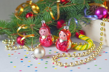 Christmas toys on the background of fir-tree branches, vintage style.