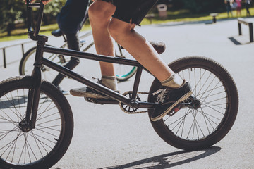 Bmx rider performing tricks at skatepark.
