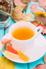 cup of tea on the table with fallen leaves