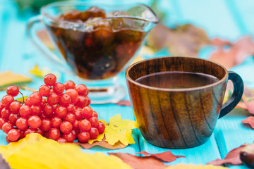 cup of tea on the table with fallen leaves