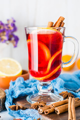 Hot tea with lemon and cinnamon in a glass. Winter warming drink