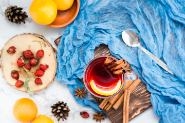 Hot tea with lemon and cinnamon in a glass. Winter warming drink. Top view