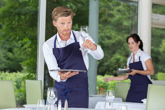 Waiter checking glassware