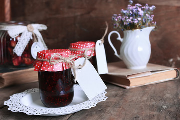 rustic homemade jam jar wooden background and flower
