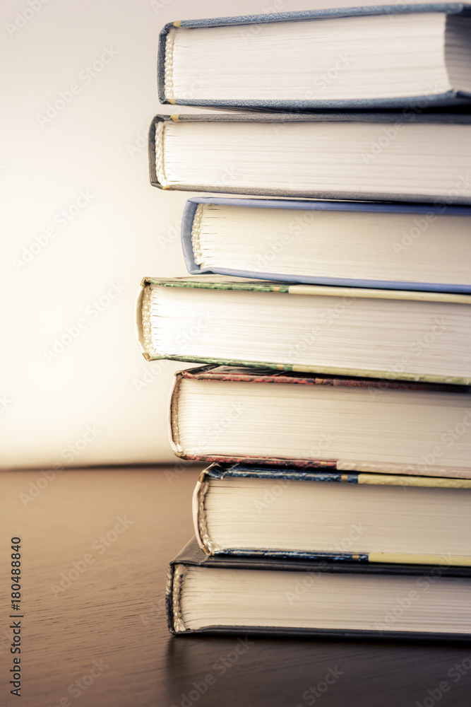 Poster stack of old books on a table to the library