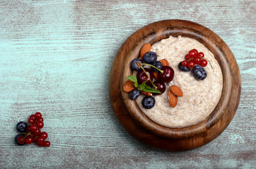 Oatmeal in bowl on wooden blue table with place for text