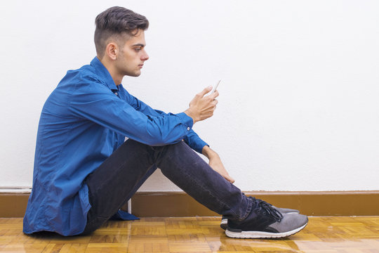 young teenager with mobile phone at home