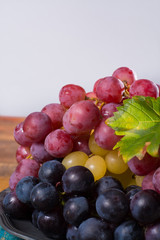 Large organic table grape Globe in assortment served on the tin plate