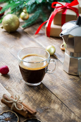 Glass of espresso coffee on vintage wooden table, christmas morning concept decoration