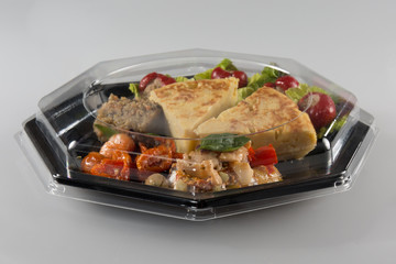 Closed transparent plastic food packaging box isolated on white