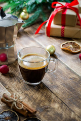 Glass of espresso coffee on vintage wooden table, christmas morning concept decoration
