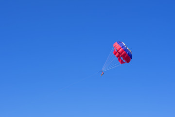 Parasilior in a blue sky. The active and extreme form of relaxation
