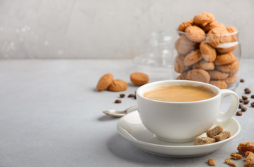 Cup of fresh coffee with Amaretti cookies on gray concrete or stone background, selective focus, copy space