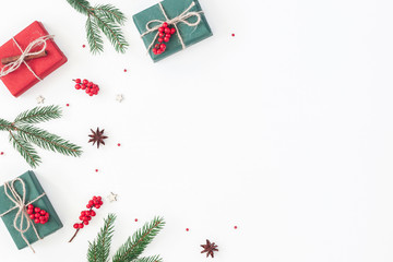Christmas composition. Frame made of christmas gifts, pine branches, toys on white background. Flat...
