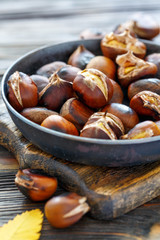 Roast chestnuts in a pan closeup.