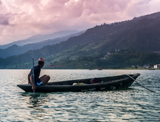 fisherman in a boat on the lake in Pokhara