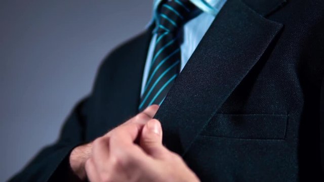 slow motion, a businessman in a suit puts the phone in his pocket