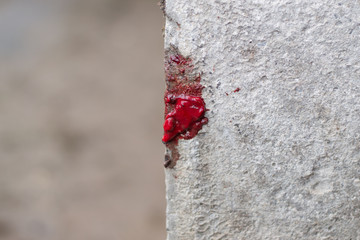 drops of blood flow down the concrete column. traces of a terrorist attack.