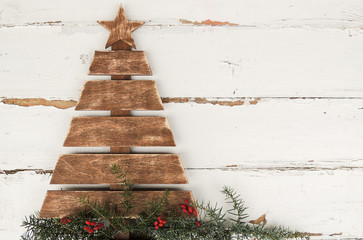 Vintage wooden Christmas tree on old rustic wooden white background.