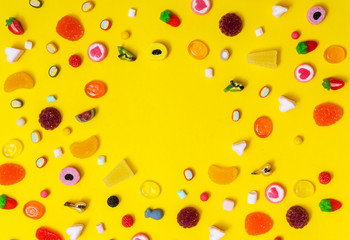 colorful candy on the yellow background