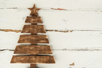 Vintage wooden Christmas tree on old rustic wooden white background.