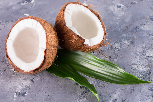 halves of coconuts on a stone background
