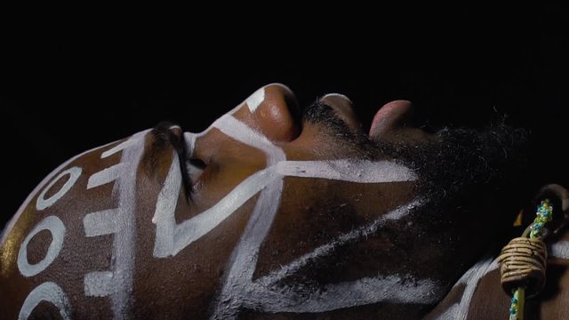 Papuan with the bulging eyes comes alive from the dead, slow motion
