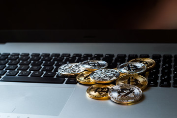 Silver and gold bitcoin on keyboard