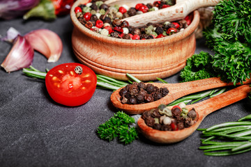 Selection of spices herbs and greens. Ingredients for cooking. Food background on black slate table.