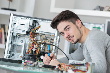 young handsome computer repairer concentrated on his work
