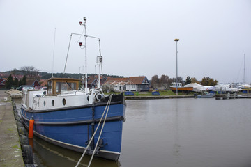 a small fishing boat by the pier