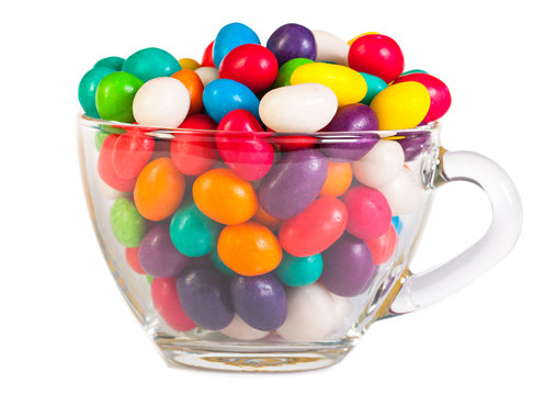 colorful candies in a glass isolated on a white background