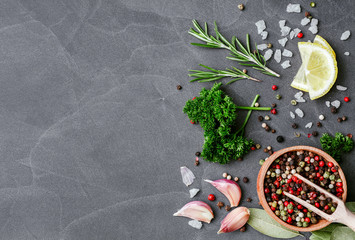 Herbs and spices over black stone background. Top view with copy space