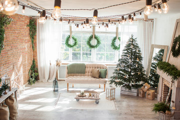 New Year and Christmas 2018. Beautiful, bright, spacious, decorated, Christmas apartment with a fireplace, a large beautiful tree and a huge window.