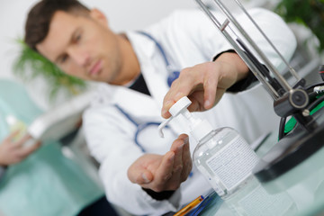 doctor disinfects his hands