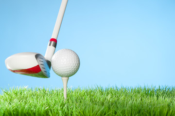 Hybrid Driver about the hit the Ball : Series of golfing equipment concept pictures..Shot in studio on grass with blue background