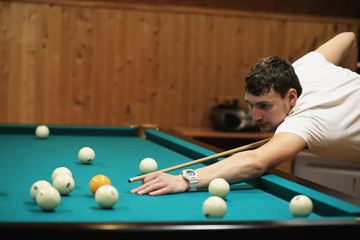 man plays billiards 