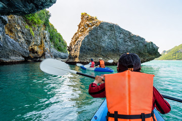 Naklejka premium Group of tourists on a kayak.Travel by boat around Ko Phi enjoy the beautiful nature of the sea and islands in the summer at Mu Ko Ang Thong National Marine Park, Surat Thani, Thailand